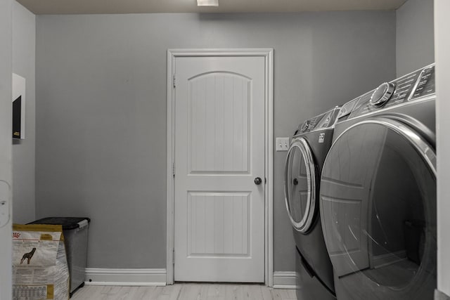 403 Mile High Ln, Midland, TX 79706 - washroom with washing machine and clothes dryer, baseboards, and light wood-style floors
