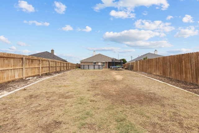 403 Mile High Ln, Midland, TX 79706 - fenced backyard with a trampoline