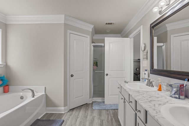 403 Mile High Ln, Midland, TX 79706 - bathroom featuring double vanity, wood finished floors, a bath, a shower stall, and baseboards