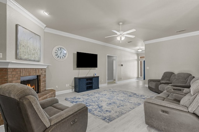 403 Mile High Ln, Midland, TX 79706 - living room featuring crown molding, ceiling fan, a fireplace, baseboards, and light wood-style flooring