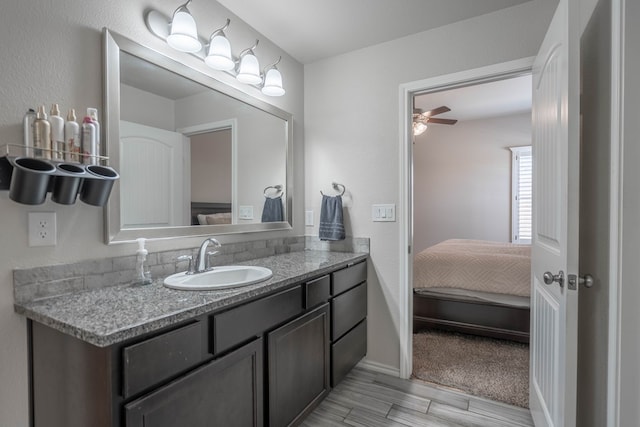 807 Bronco Ct, Midland, TX 79705 - bathroom with vanity, ensuite bathroom, ceiling fan, and wood finished floors