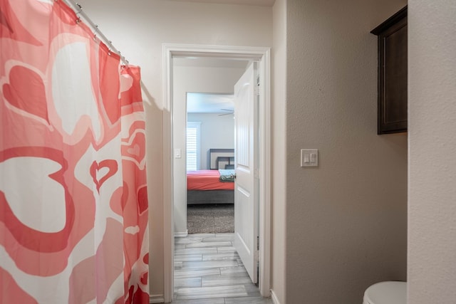 807 Bronco Ct, Midland, TX 79705 - full bathroom featuring wood finished floors and a shower with shower curtain