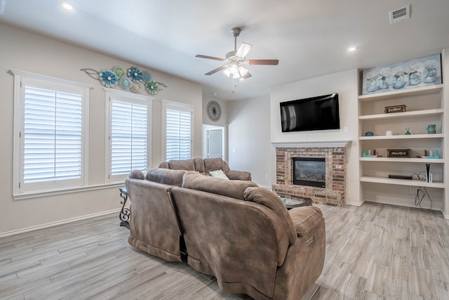807 Bronco Ct, Midland, TX 79705 - living area featuring a ceiling fan, wood finished floors, and a brick fireplace