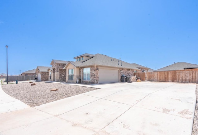 807 Bronco Ct, Midland, TX 79705 - view of front of house featuring a garage, brick siding, and driveway
