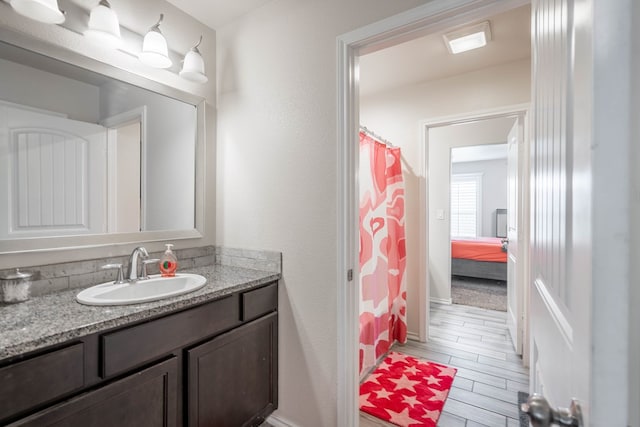 807 Bronco Ct, Midland, TX 79705 - bathroom featuring vanity, wood finished floors, and curtained shower