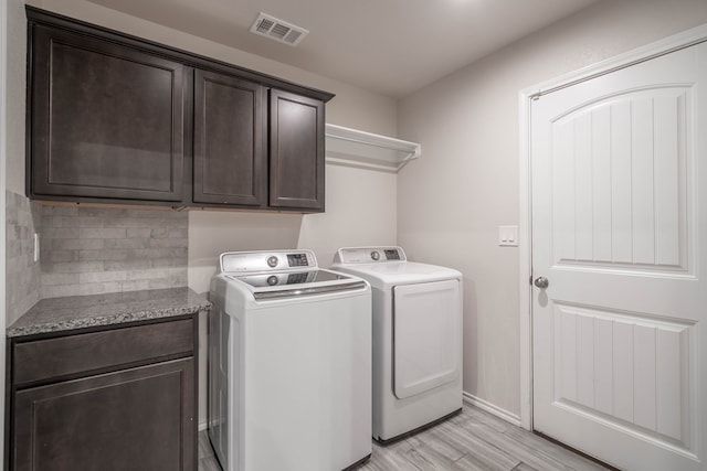 807 Bronco Ct, Midland, TX 79705 - laundry room featuring cabinet space, washing machine and clothes dryer, and light wood-style flooring