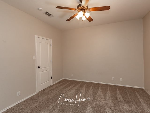 spare room featuring carpet, visible vents, ceiling fan, and baseboards