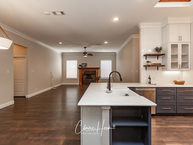 5305 Wimberley Spring Ct, Midland, TX 79707 - kitchen with open shelves, ceiling fan, a sink, light countertops, and a fireplace