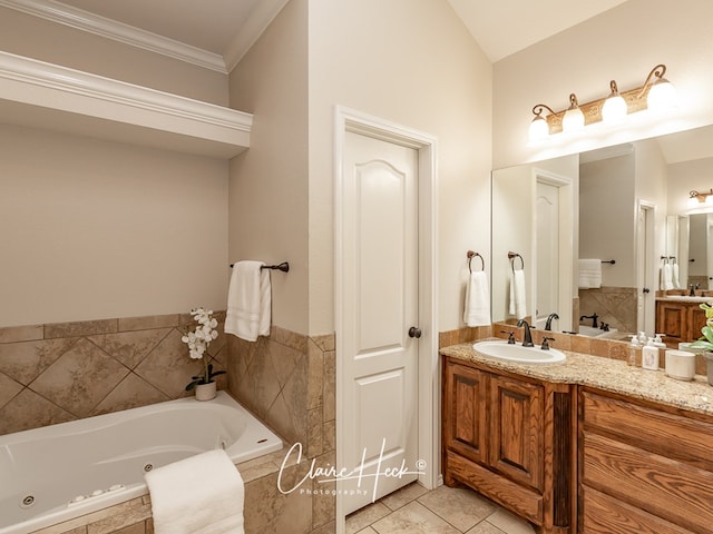 full bath featuring a jetted tub, tile patterned flooring, ornamental molding, and vanity