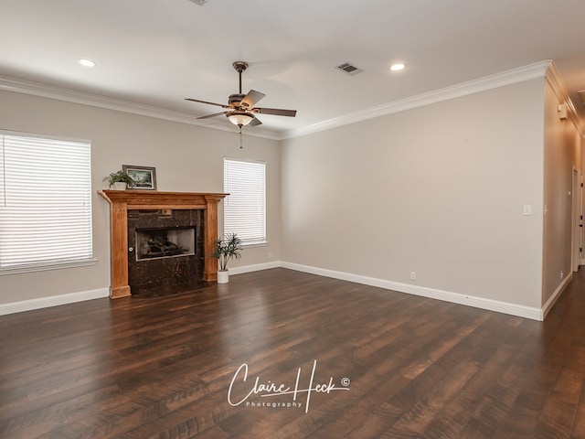 living room with ornamental molding, a high end fireplace, and visible vents