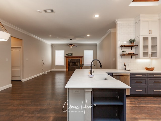 kitchen featuring visible vents, light countertops, a fireplace, open shelves, and a sink