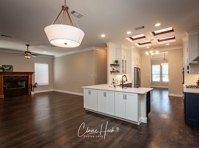 kitchen with visible vents, freestanding refrigerator, and crown molding