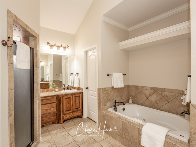 full bathroom featuring ornamental molding, a stall shower, a garden tub, and vanity