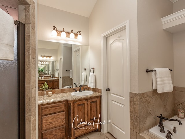 5305 Wimberley Spring Ct, Midland, TX 79707 - full bathroom featuring vanity, a garden tub, lofted ceiling, and tile patterned floors