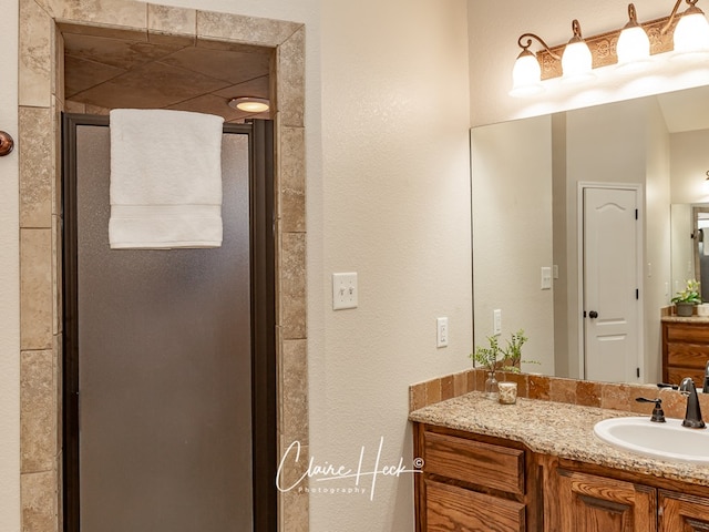 bathroom featuring a stall shower and vanity