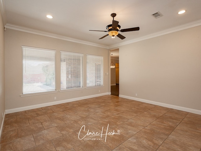 empty room with baseboards, visible vents, a ceiling fan, and ornamental molding