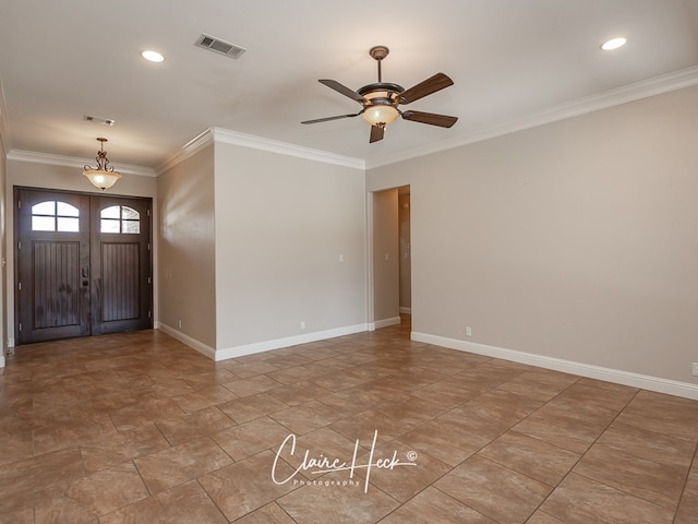 entryway with baseboards, ceiling fan, visible vents, and crown molding