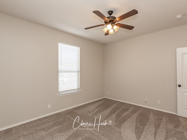 empty room featuring carpet, a ceiling fan, and baseboards