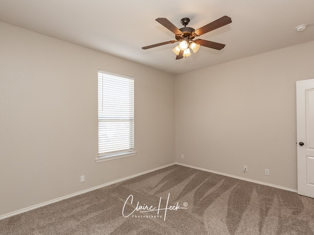 5305 Wimberley Spring Ct, Midland, TX 79707 - empty room featuring dark carpet, ceiling fan, baseboards, and a smoke detector
