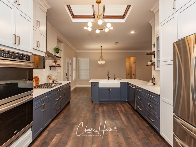 5305 Wimberley Spring Ct, Midland, TX 79707 - kitchen featuring appliances with stainless steel finishes, open shelves, a sink, a peninsula, and crown molding