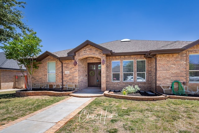 5305 Wimberley Spring Ct, Midland, TX 79707 - single story home with brick siding, a front lawn, and roof with shingles