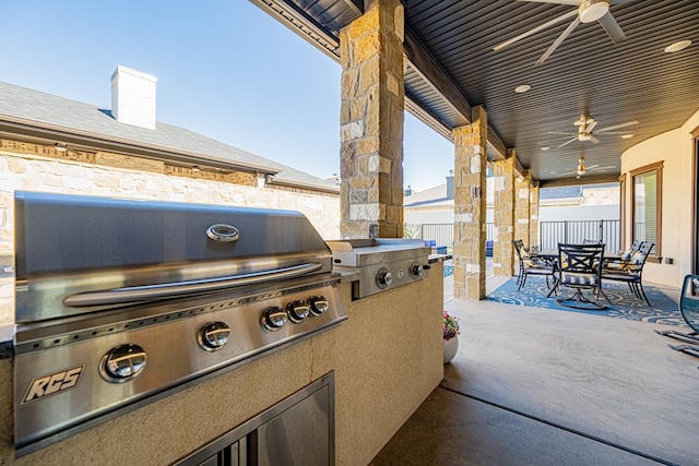 view of patio / terrace featuring exterior kitchen, a grill, and ceiling fan