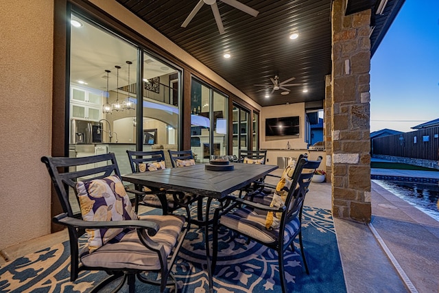 view of patio / terrace with a swimming pool and ceiling fan