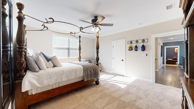 carpeted bedroom with ornamental molding