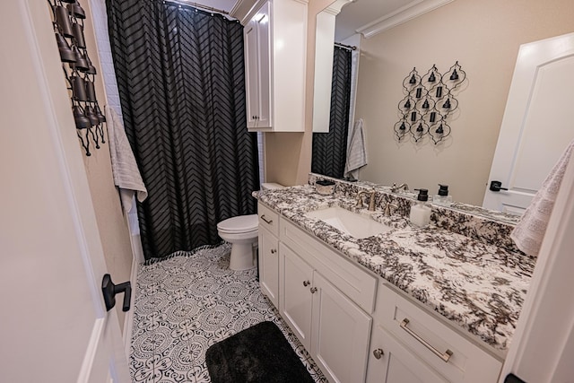 bathroom with ornamental molding, vanity, toilet, and tile patterned floors