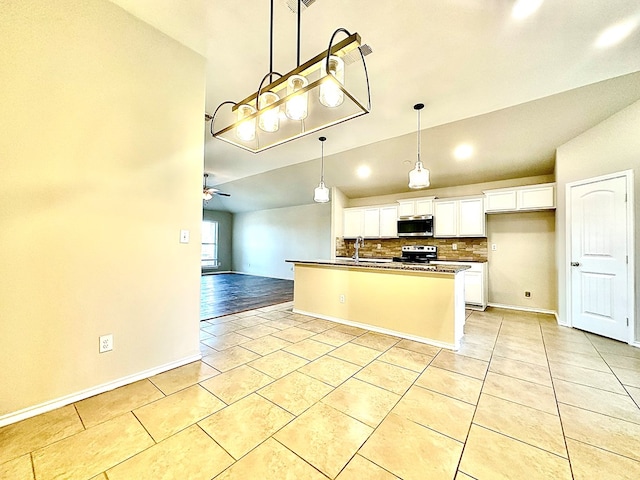 1401 Brand Ln, Midland, TX 79705 - kitchen featuring range with electric stovetop, open floor plan, stainless steel microwave, and light tile patterned floors