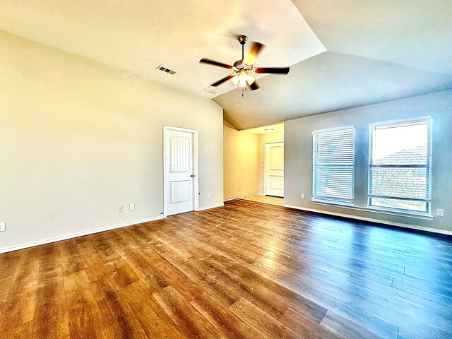 1401 Brand Ln, Midland, TX 79705 - empty room featuring wood finished floors, ceiling fan, baseboards, lofted ceiling, and visible vents