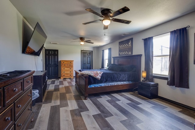 600 NW 8th St, Big Spring, TX 79720 - bedroom with dark wood-style floors and ceiling fan