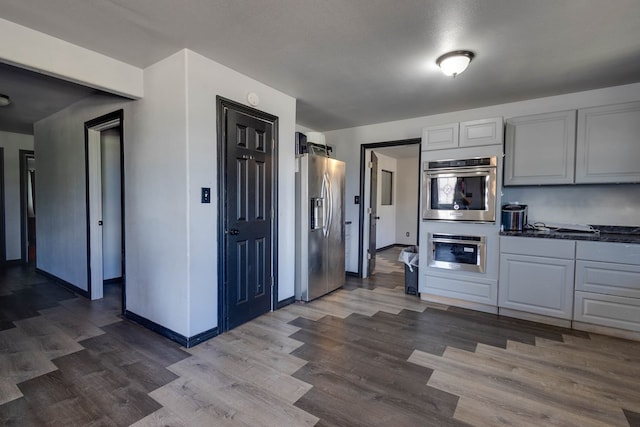 600 NW 8th St, Big Spring, TX 79720 - kitchen with stainless steel appliances and dark wood-style flooring