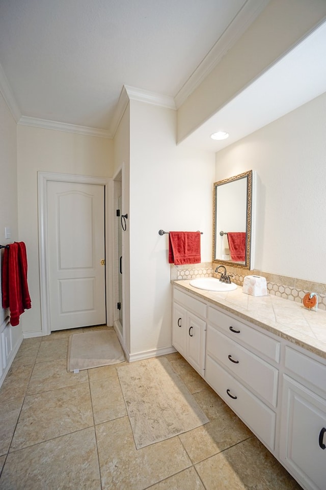 bathroom featuring ornamental molding, vanity, and baseboards