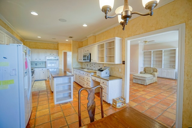 kitchen featuring white appliances, a kitchen island, white cabinetry, open shelves, and crown molding