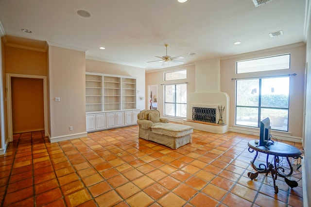 living area featuring light tile patterned floors, visible vents, a fireplace with raised hearth, and crown molding