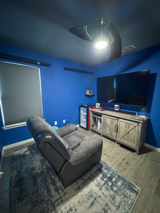 interior space with visible vents, ceiling fan, baseboards, and wood finished floors