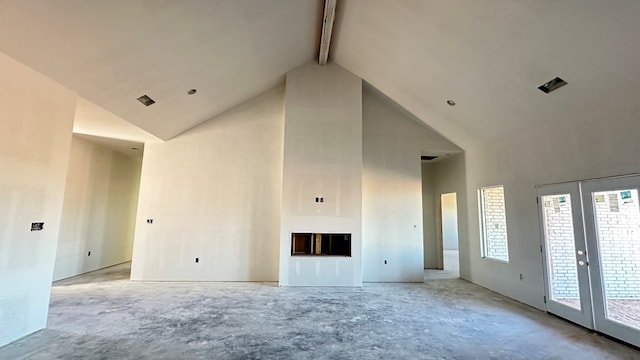 unfurnished living room with beam ceiling, a fireplace, french doors, and high vaulted ceiling