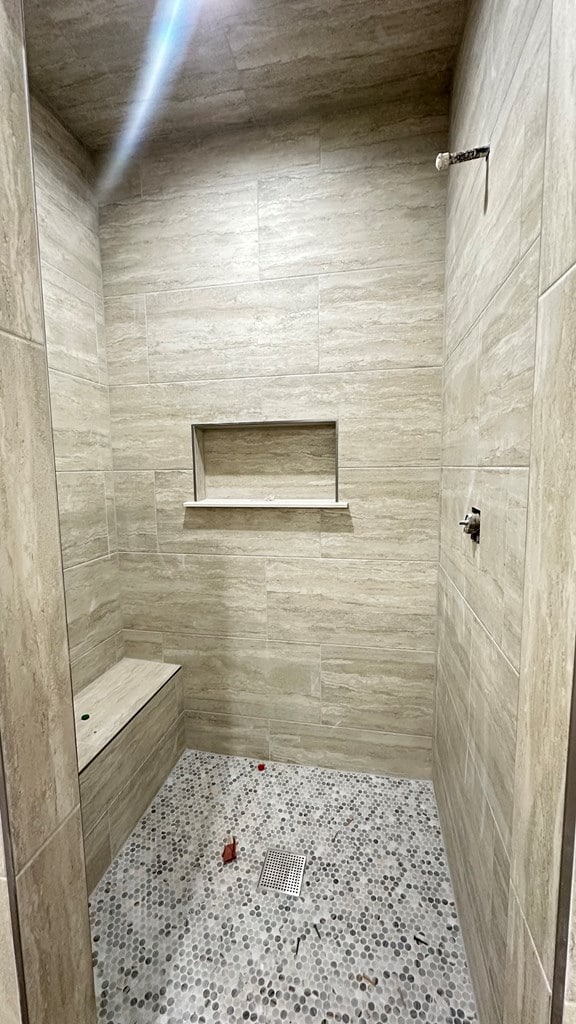 full bath with a tile shower