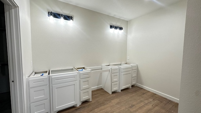 bathroom featuring baseboards and wood finished floors