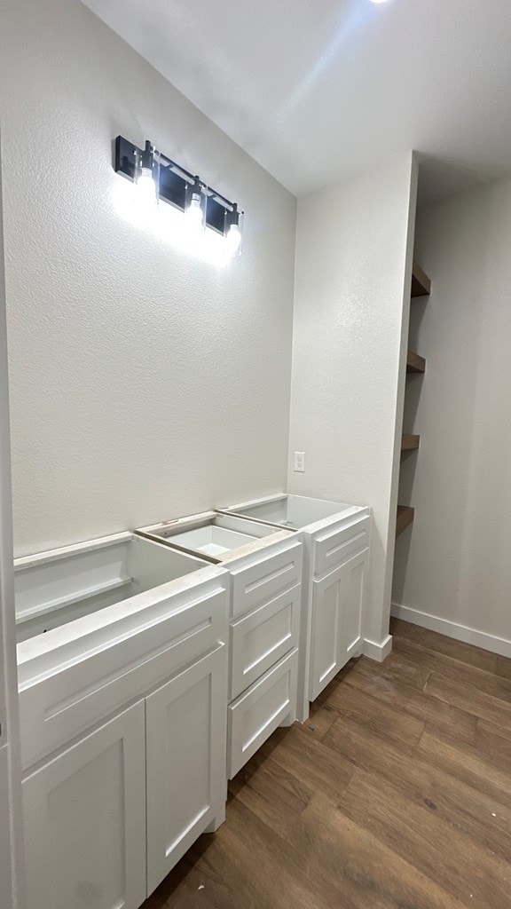 bathroom with wood finished floors and baseboards