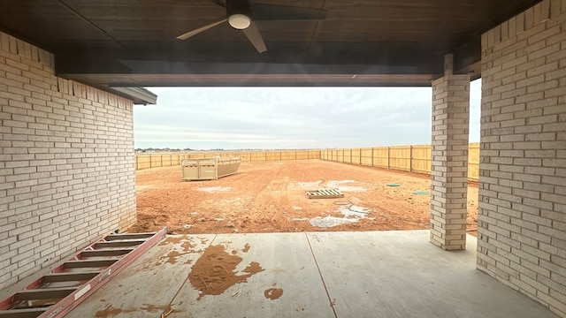 view of yard featuring a fenced backyard, a ceiling fan, and a patio area