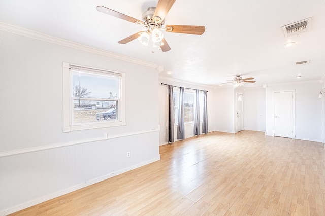 unfurnished room with light wood-style floors, visible vents, crown molding, and a ceiling fan