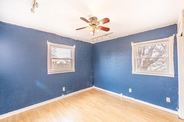 1204 Tinker St, Seagraves, TX 79359 - unfurnished room with light wood-type flooring, track lighting, baseboards, and a ceiling fan