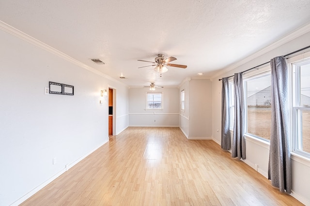 1204 Tinker St, Seagraves, TX 79359 - unfurnished room with a textured ceiling, light wood-style flooring, visible vents, baseboards, and ornamental molding