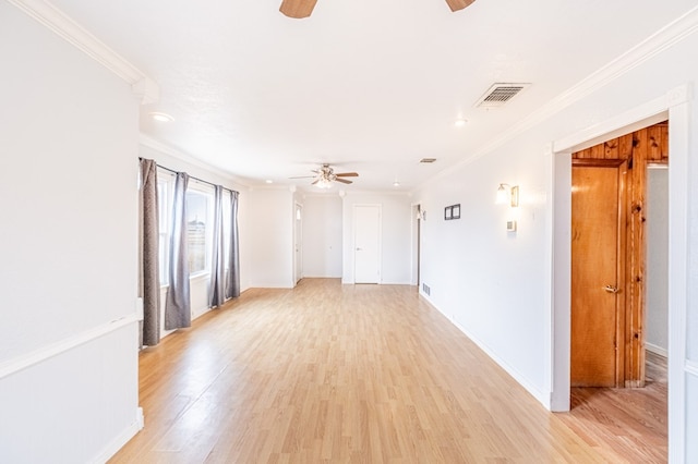 1204 Tinker St, Seagraves, TX 79359 - spare room featuring visible vents, light wood-style floors, baseboards, a ceiling fan, and crown molding