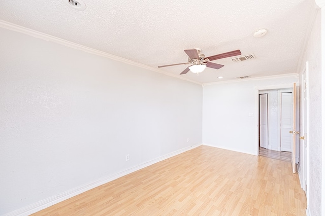 1204 Tinker St, Seagraves, TX 79359 - unfurnished room featuring light wood finished floors, a textured ceiling, visible vents, and crown molding