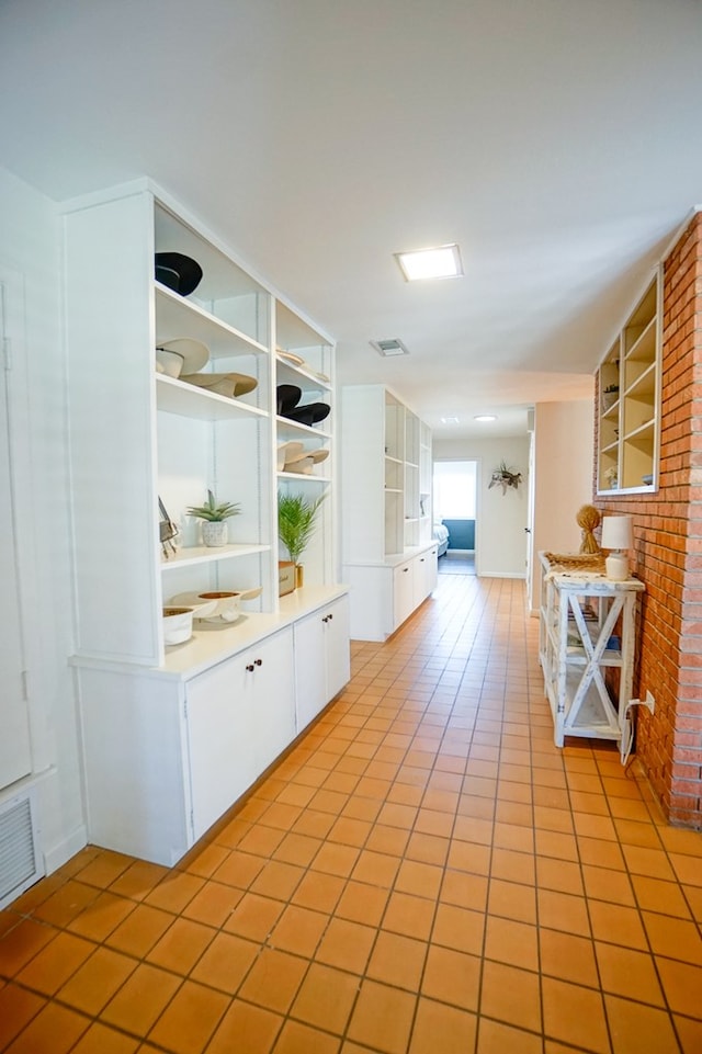 kitchen featuring white cabinets and light tile patterned floors