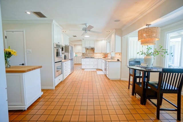 kitchen featuring ceiling fan, sink, white cabinets, and ornamental molding