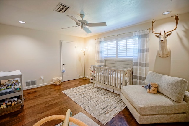 bedroom with ceiling fan and hardwood / wood-style flooring